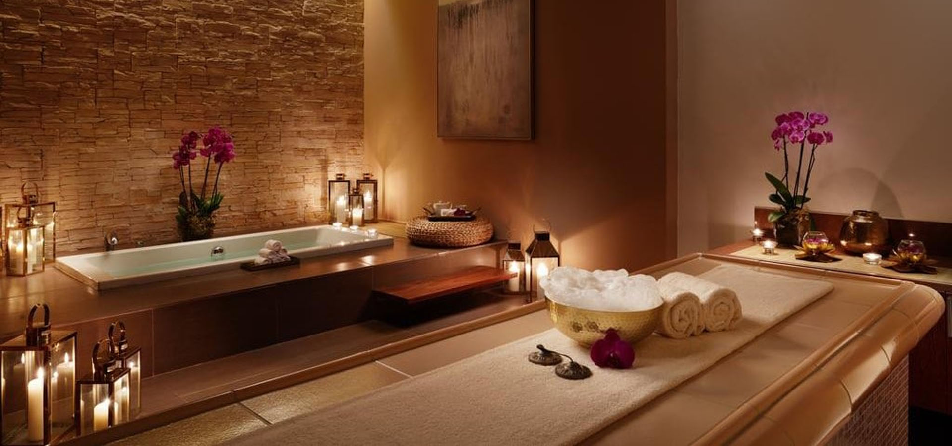 Luxurious spa room at Glamour Massage Center Islamabad featuring a massage bed, plush towels, and an elegant bathtub for a serene and relaxing experience.